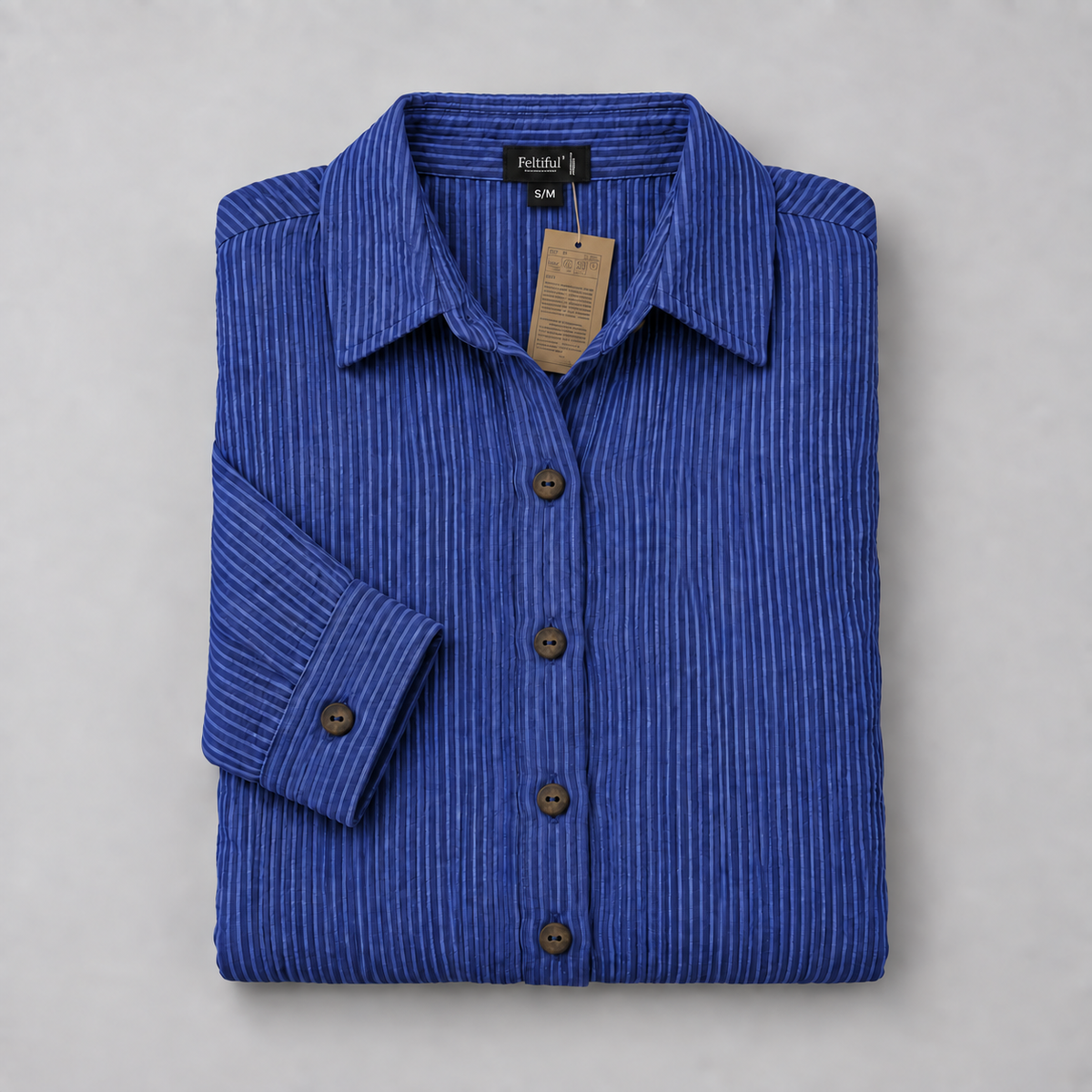 Folded blue pinstripe shirt dress with Feltiful label, hanging tag and two-hole brown buttons