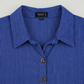 Collar and two-hole brown button detail of blue pinstripe cotton tunic
