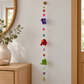 Elephant and flower hanging displayed beside an entryway console