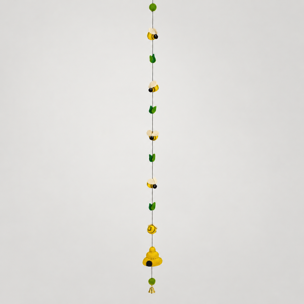 BC511 48-inch wool bee and beehive hanging with green leaves and bell on warm gray