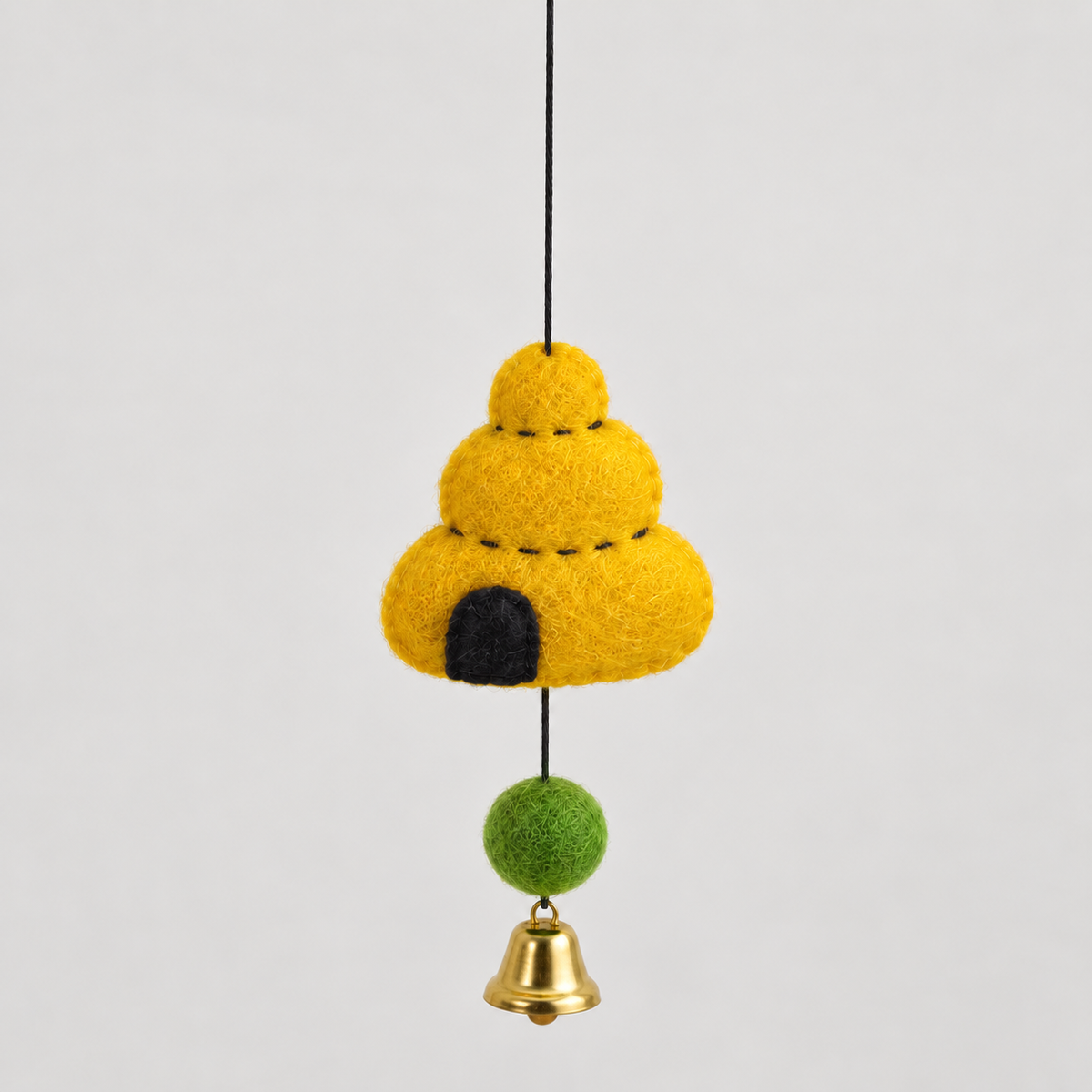 Yellow felt beehive, green wool ball and bell detail
