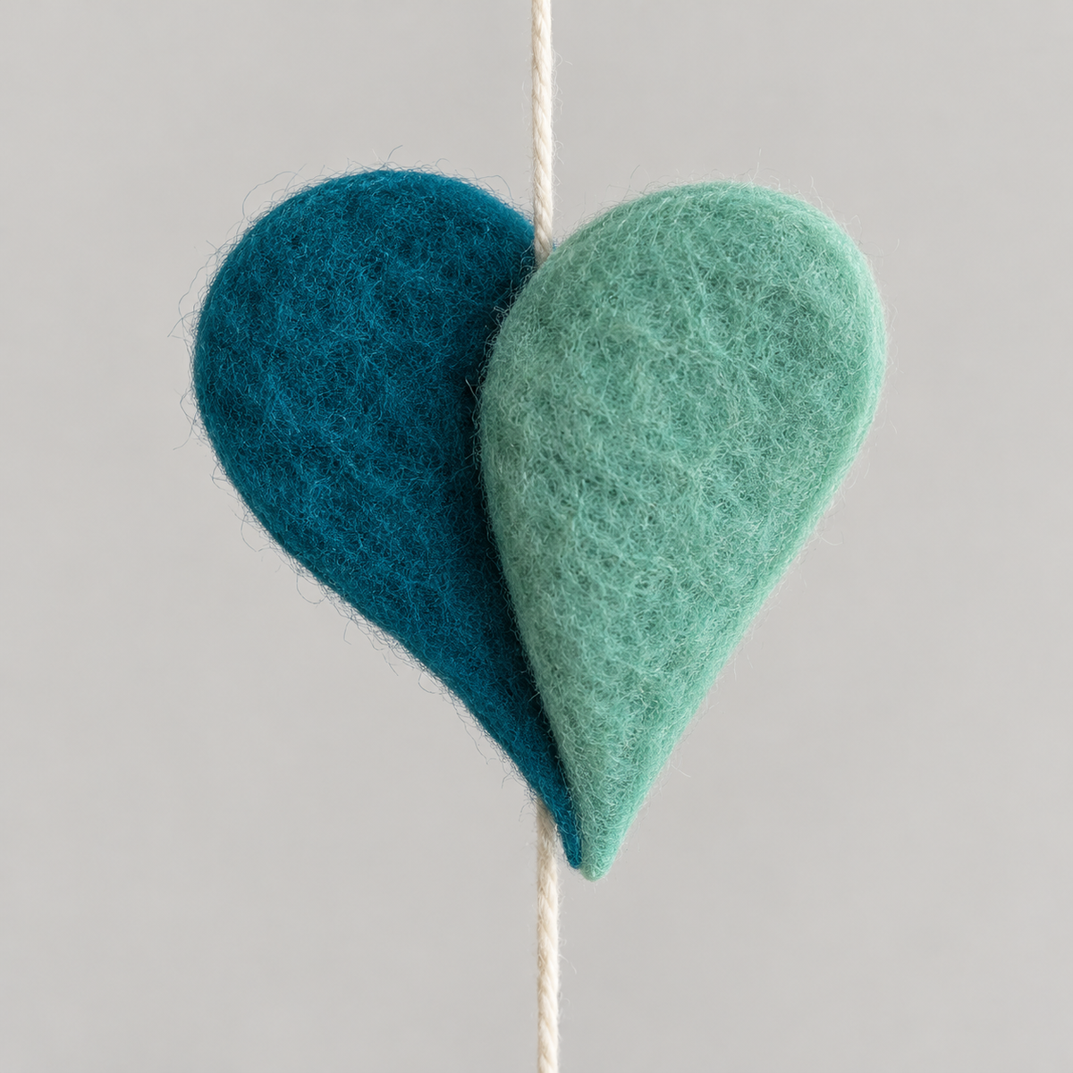 Layered teal and seafoam felt heart texture detail