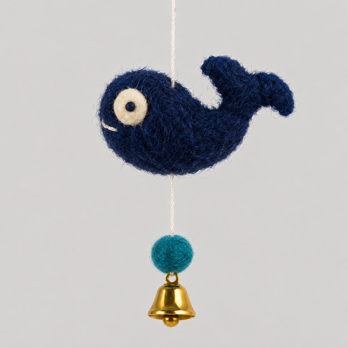 Navy wool whale with teal ball and gold bell detail