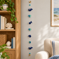 Whale and heart garland displayed beside an oak bookcase
