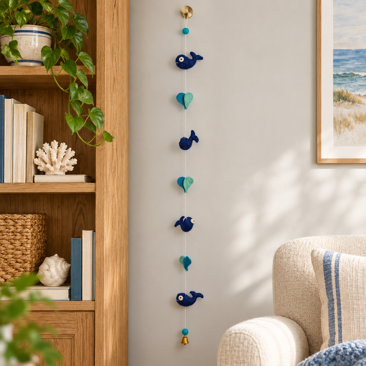Whale and heart garland displayed beside an oak bookcase