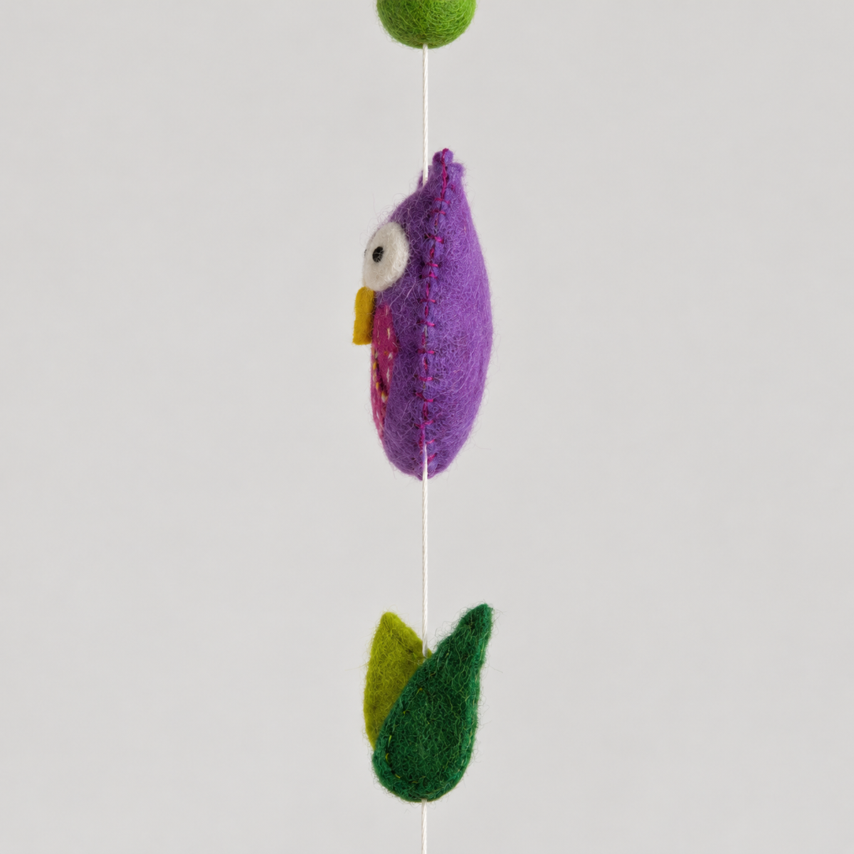 Purple wool owl side profile and green felt leaves