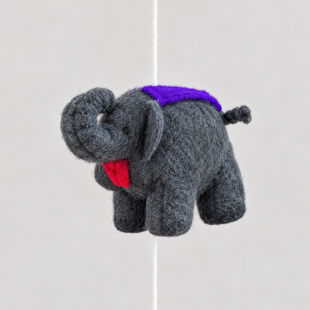 Gray wool elephant with purple saddle close-up