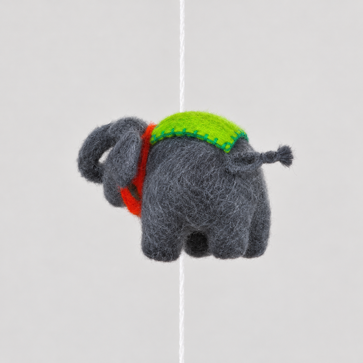 Gray wool elephant with green saddle detail
