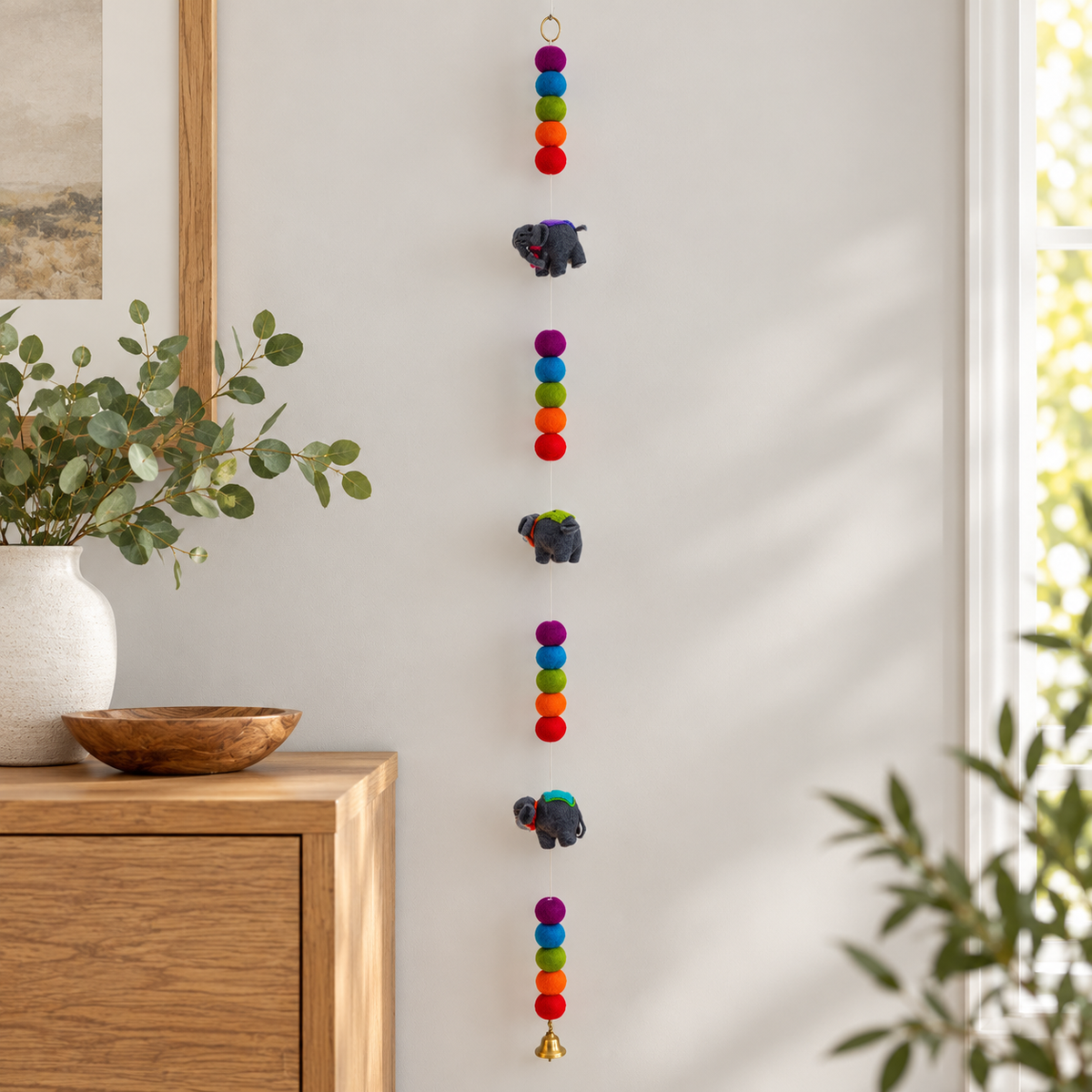 Elephant garland displayed beside a wooden console
