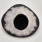 Charcoal and light-gray handmade wool cat cave on warm soft gray background