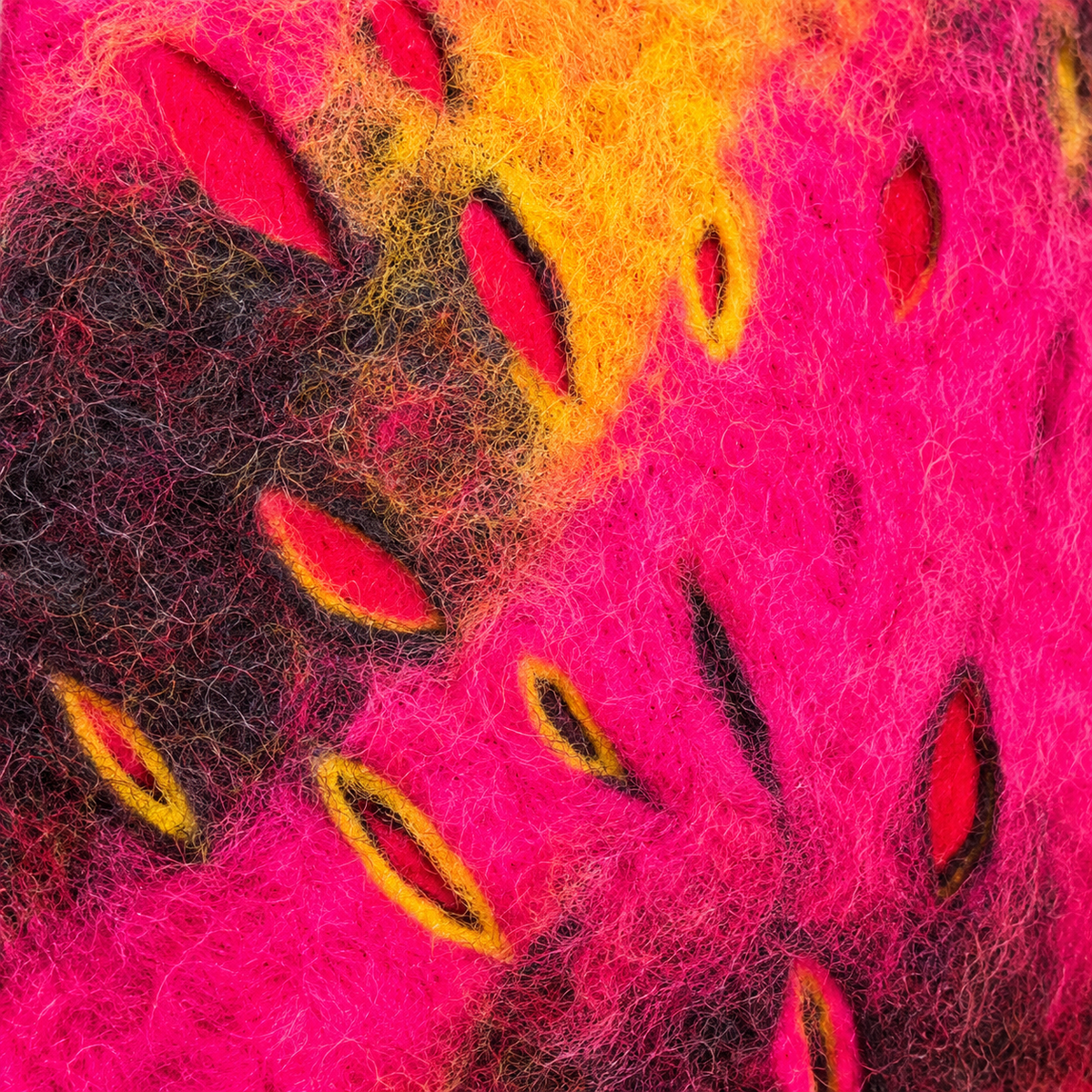 Macro detail of pink orange and charcoal felt wool texture