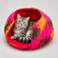 Silver tabby cat resting naturally inside the colorful wool cat cave