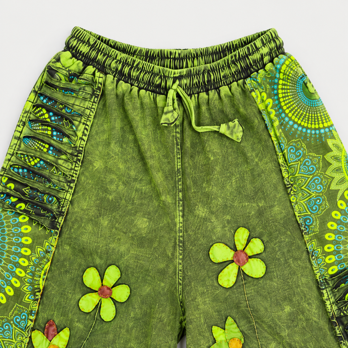 Elastic waistband and drawstring detail on green cotton pants