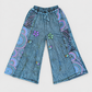 Washed blue floral cotton wide-leg pants on a clean light-gray background