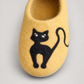 Black cat motif and yellow wool texture close-up