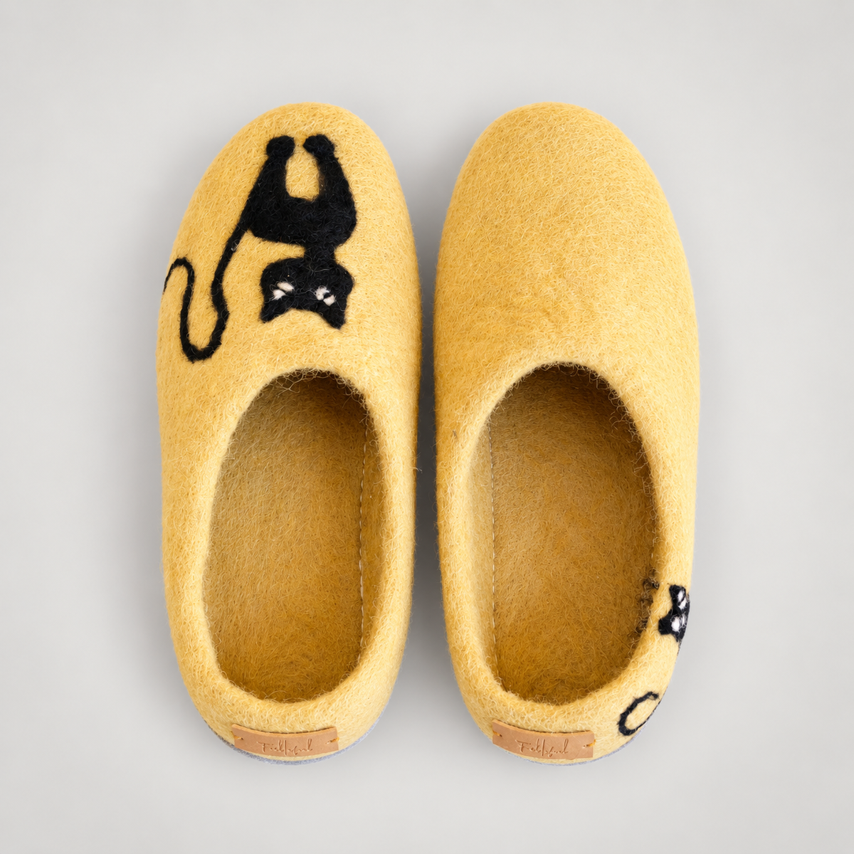 Overhead view of yellow wool cat slippers