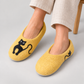 Model wearing yellow wool cat slippers