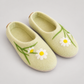 Front view of pale green daisy wool felt slippers