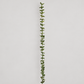 Full-length green wool leaf garland on warm gray background