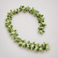 Green wool garland in curved arrangement