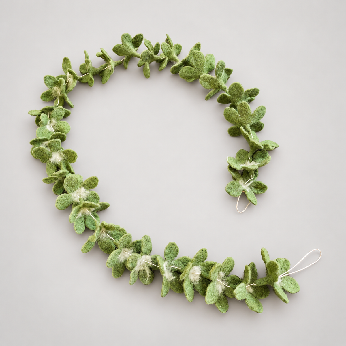 Green wool garland in curved arrangement