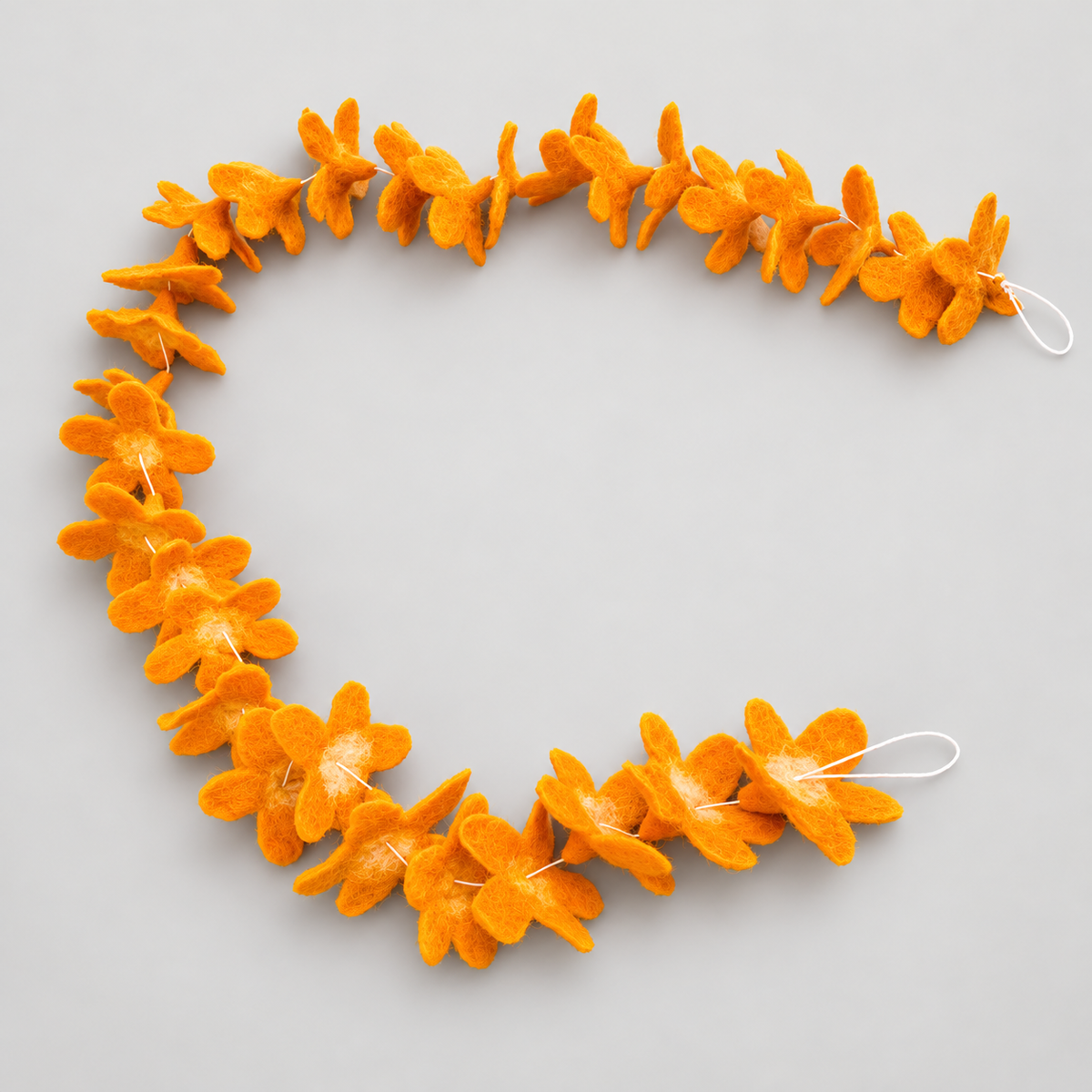 Orange wool flower garland in a curved arrangement