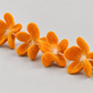 Angled detail of handmade orange felt petals