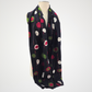black scarf with red, green and ivory dots and fine red lines, draped on a mannequin