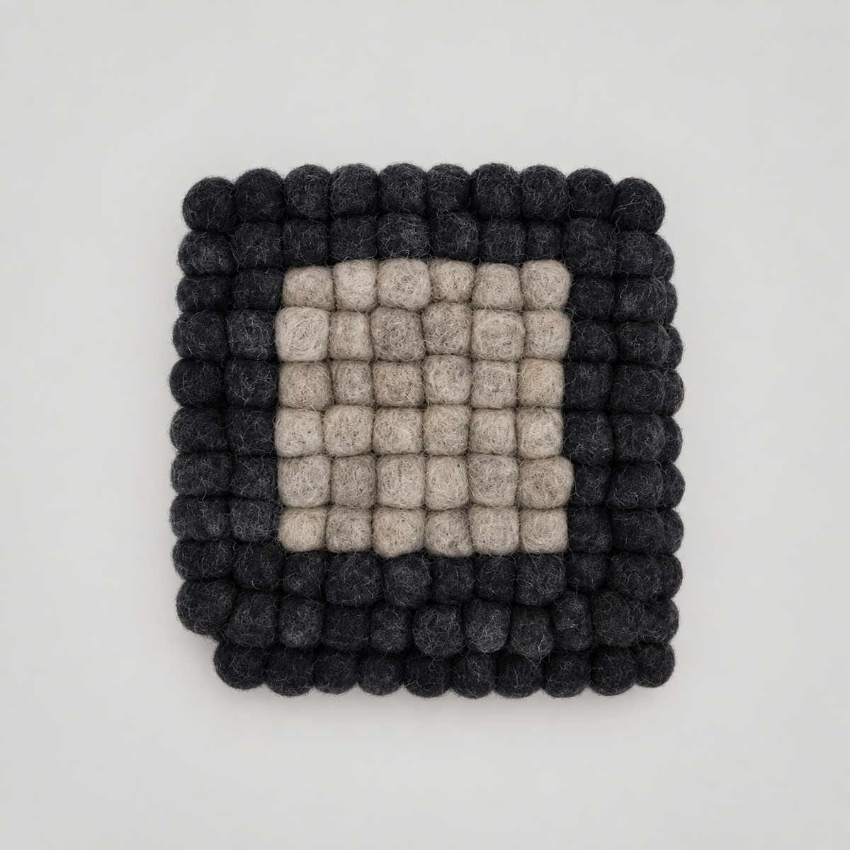 Coasters by Feltiful on a soft warm gray background