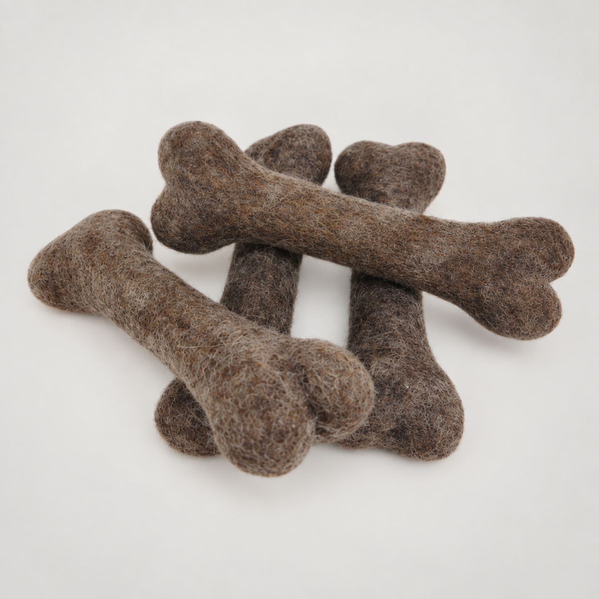 Felted Bone, Dog Toys on a soft warm gray background
