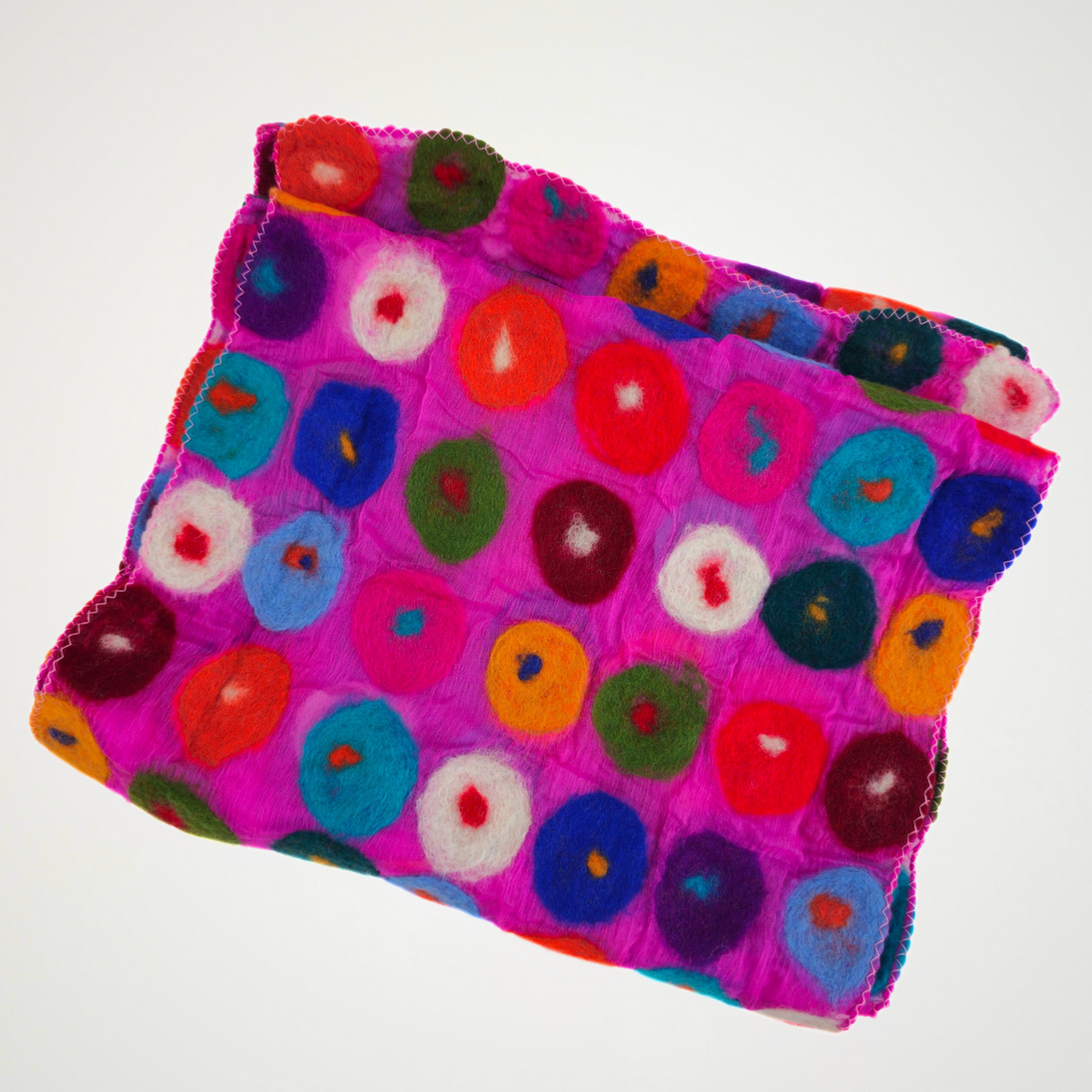 fuchsia scarf covered with multicolored circle motifs, folded detail