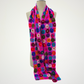fuchsia scarf covered with multicolored circle motifs, draped on a mannequin