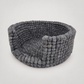 Hand Felted Po Pom Dog Bed on a soft warm gray background