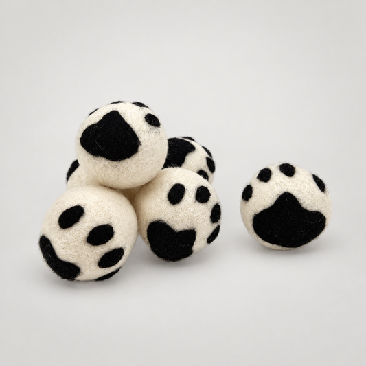 Handmade Paw Rattler Ball on a soft warm gray background