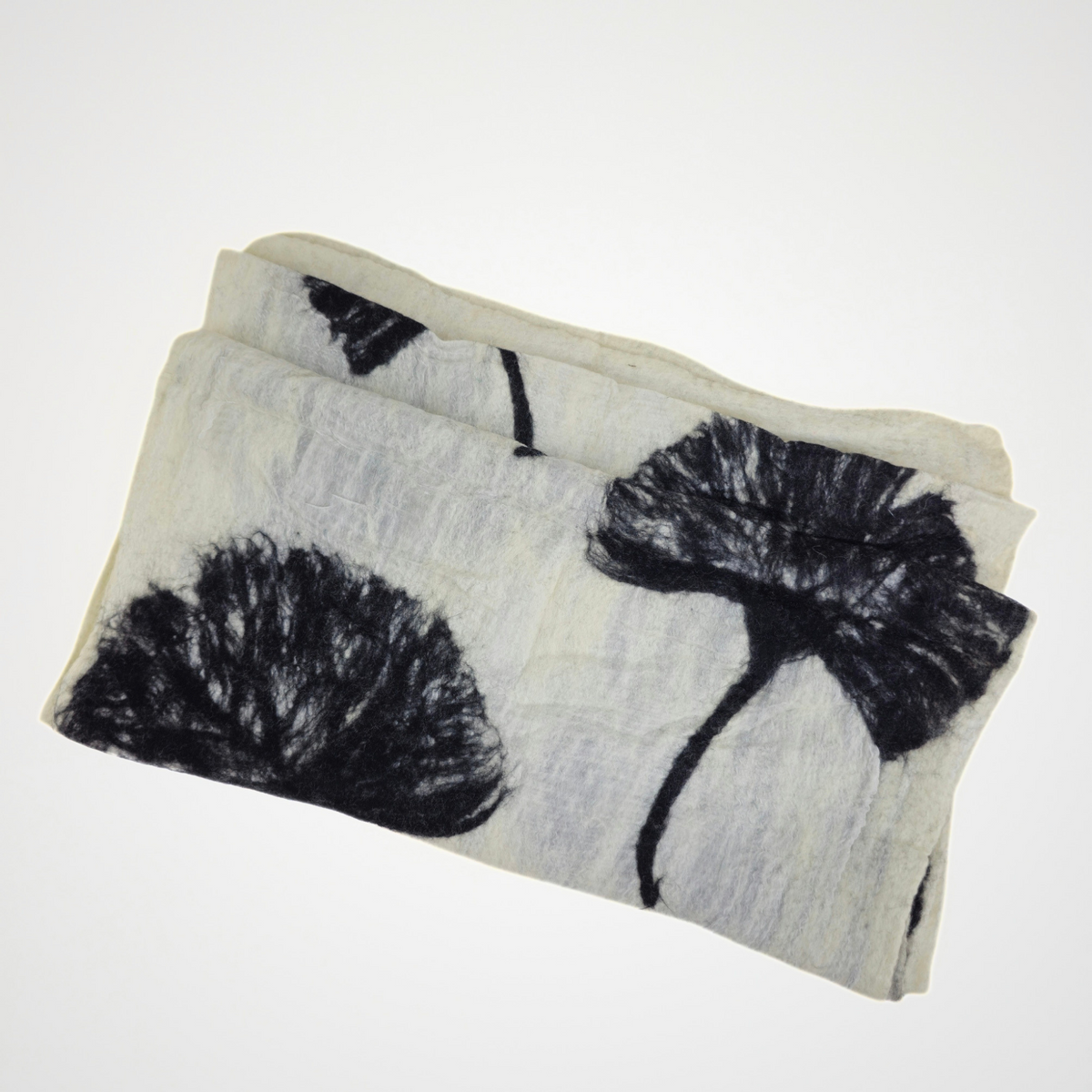 ivory scarf with black ginkgo leaf motifs, folded detail