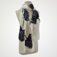 ivory scarf with black ginkgo leaf motifs, looped around a mannequin's neck