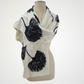 ivory scarf with black ginkgo leaf motifs, wrapped across a mannequin's shoulders
