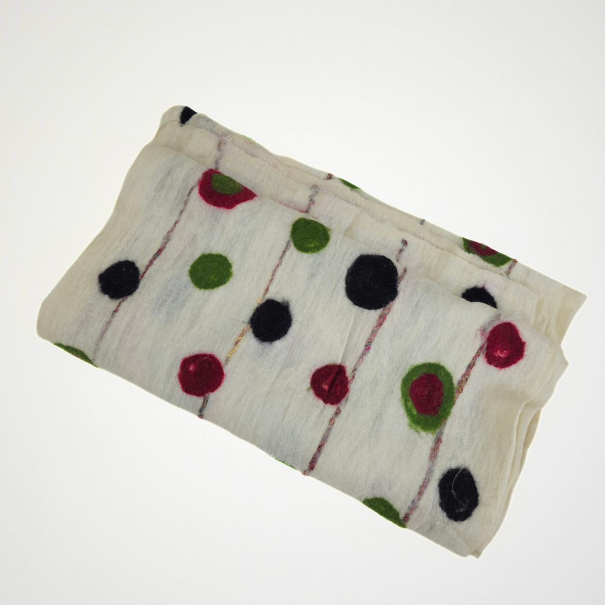 ivory scarf with red, green and black dots and fine vertical lines, folded detail
