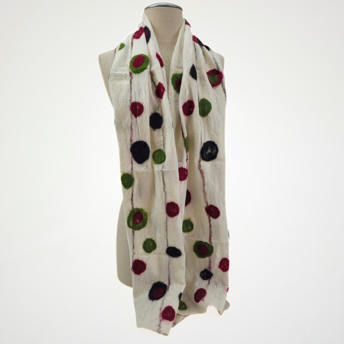 ivory scarf with red, green and black dots and fine vertical lines, draped on a mannequin