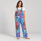 Woman wearing KD617 blue patchwork cotton overalls with one hand at the pocket