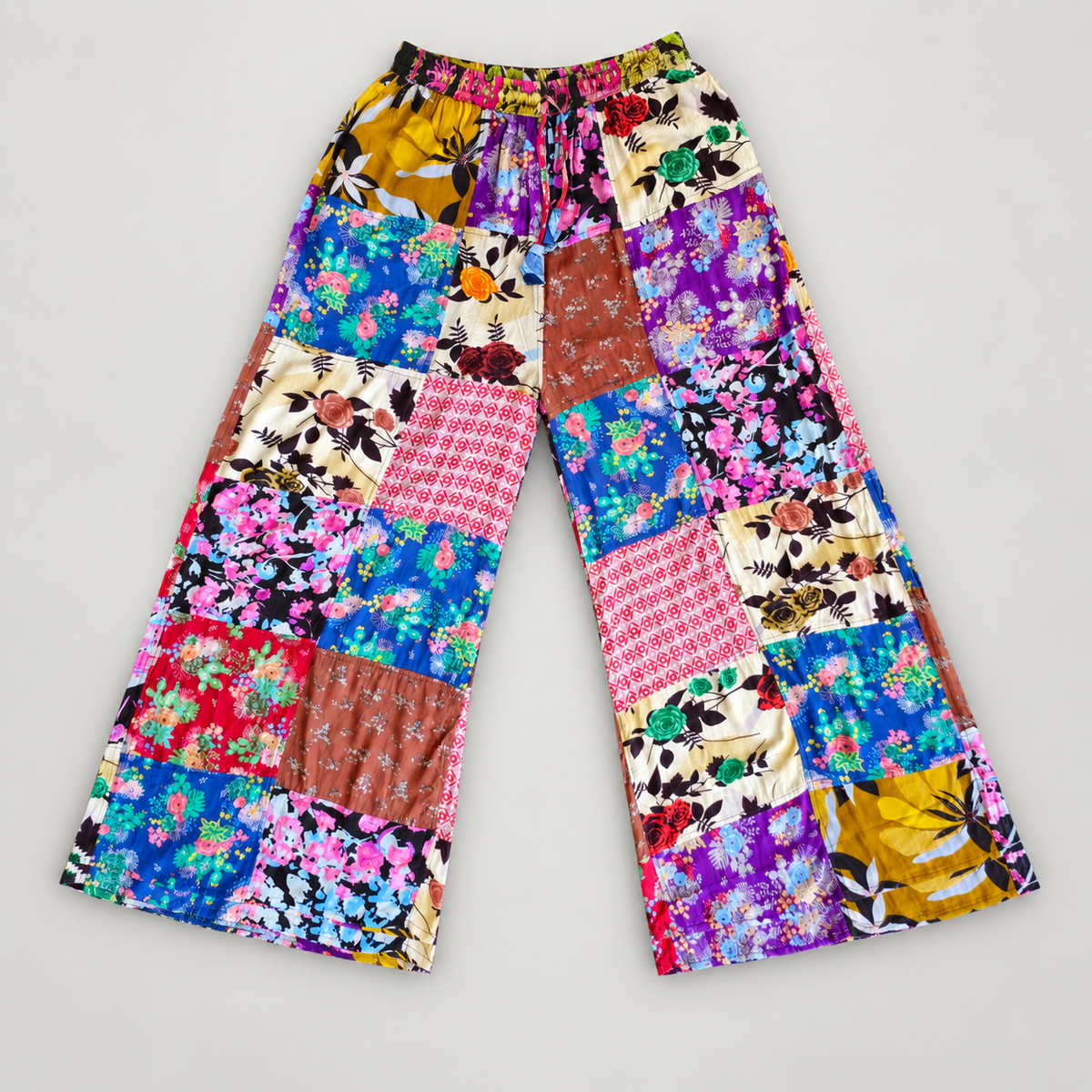Floral patchwork cotton wide-leg pants, full front view on warm gray