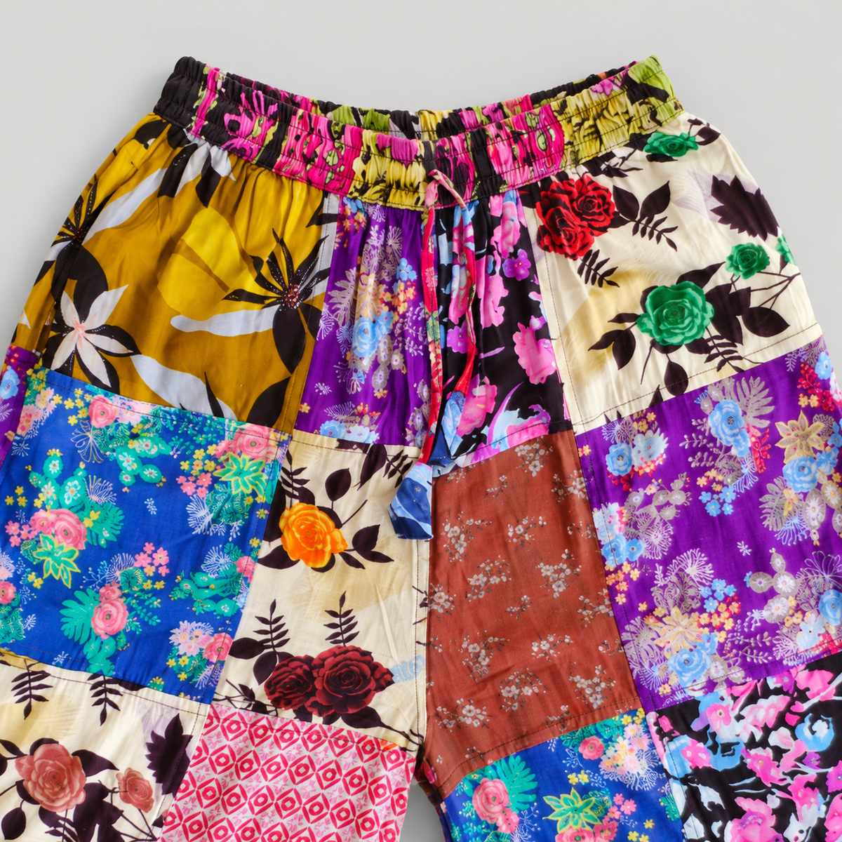 Elastic waistband and drawstring detail of floral patchwork cotton pants