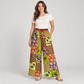 Woman wearing green patchwork cotton trousers with one hand in a pocket