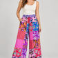 Model wearing pink patchwork cotton wide-leg trousers with one hand in a pocket