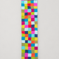 Multicolor checker felt wool table runner on warm gray background