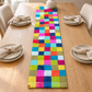 Multicolor checker runner centered on a decorated dining table