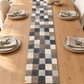 Checker wool runner centered on a decorated oak dining table