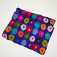 purple scarf covered with multicolored circle motifs, folded detail