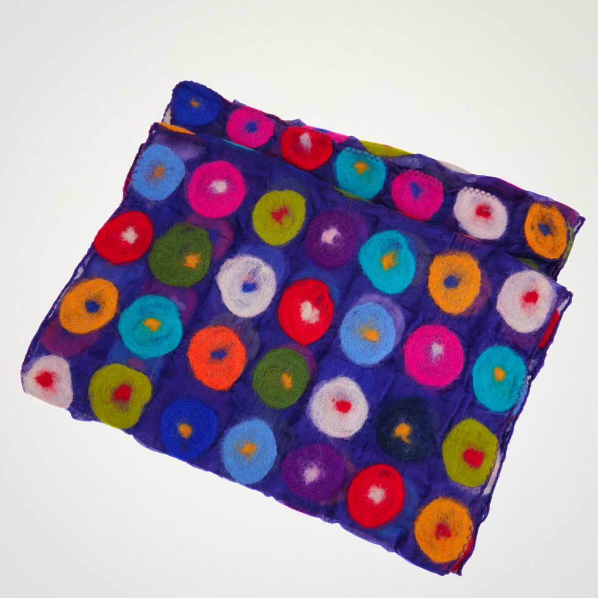 purple scarf covered with multicolored circle motifs, folded detail