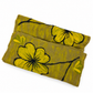 Close view of a folded mustard yellow and taupe floral felted scarf